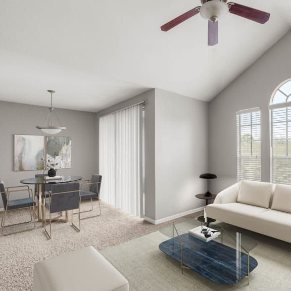a living room with a white couch and a table with chairs at Veranda at Centerfield in Houston, Texas 77070