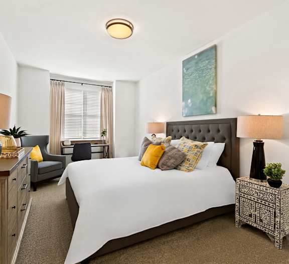a bedroom with a large bed and a ceiling fan
