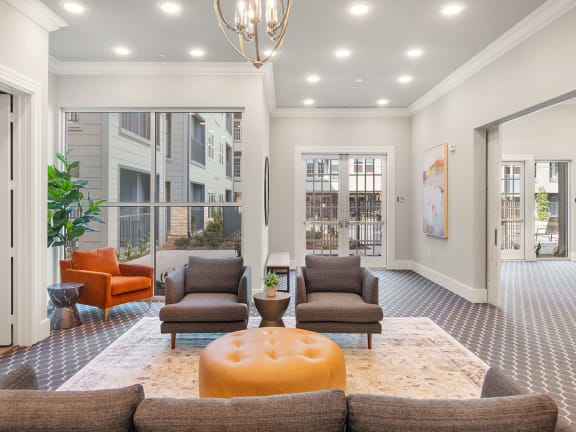 a living room with couches and chairs and a chandelier