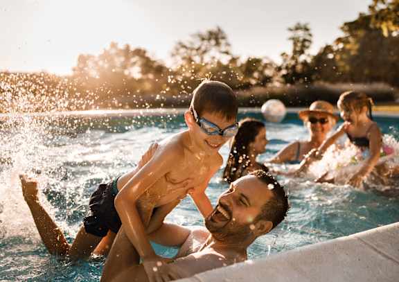 A group of people are enjoying a swim in a pool.