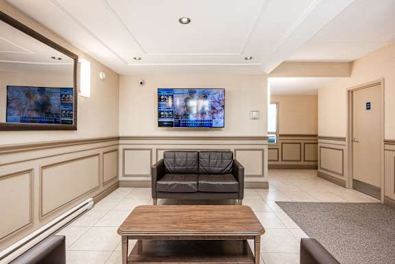 the waiting room of a hospital with a couch and a table