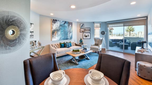 a living room with a couch and a table  at Esprit Apartments, Marina del Rey, CA