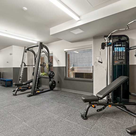 A gym with a variety of equipment including a leg press machine.