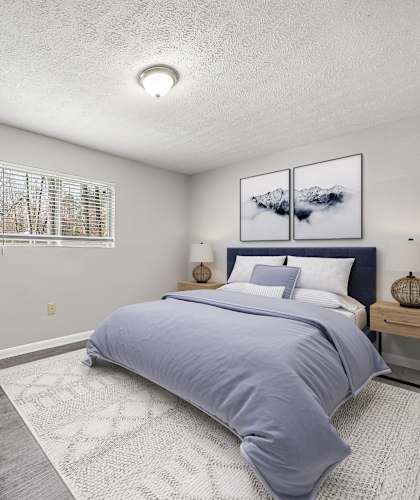 a bedroom with a bed and a chair
