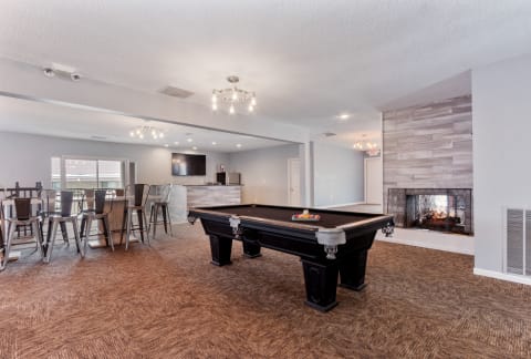 the preserve at ballantyne commons clubhouse with pool table and fireplace  at Eastwood Crossings in Kansas City, Missouri