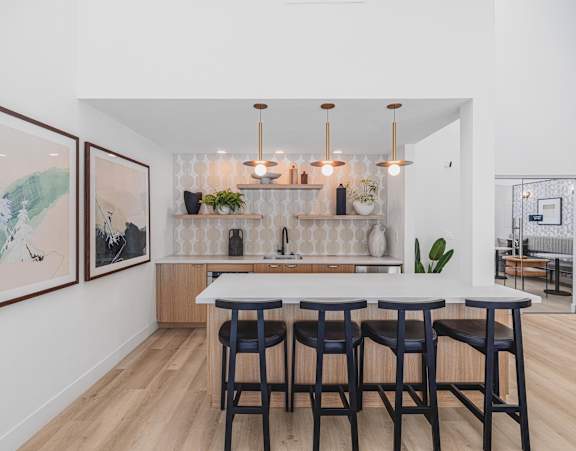 A kitchen with a bar area and a dining table.