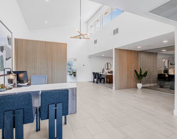 A modern dining area with a long table and chairs.
