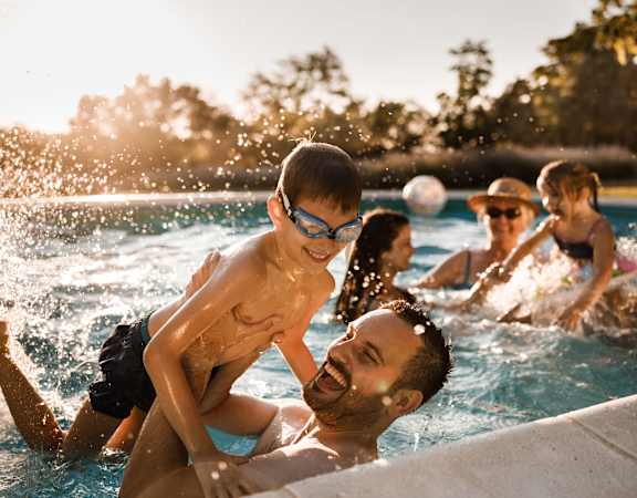 A group of people are enjoying a swim in a pool.