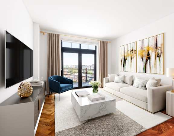 a living room with a white couch and a television