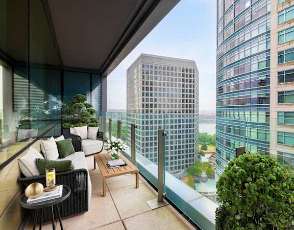 a terrace with a couch and a table on a balcony