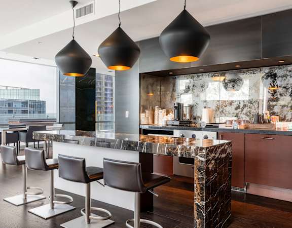 a kitchen with a marble counter top and bar stools