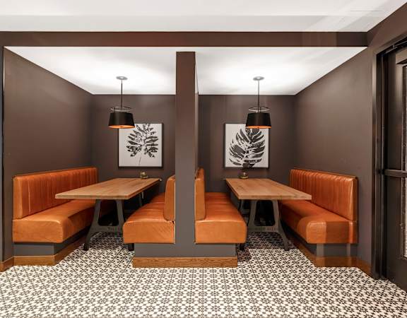 a dining room with two tables and two benches and two chairs