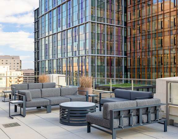a terrace with couches and a coffee table on a roof at The Bartlett in Arlington, VA 22202
