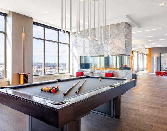 a games room with a pool table and a view of the city at The Bartlett in Arlington, VA 22202