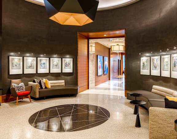 a lobby with couches and pictures on the wall at The Bartlett in Arlington, VA 22202