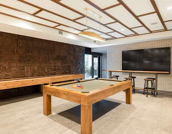 a game room with a pool table and a television