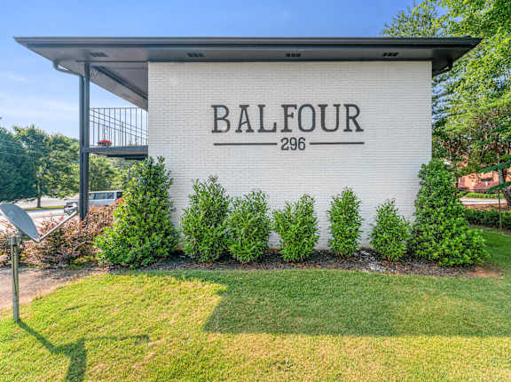 A white building with the name Balfour and the number 296 on it at Balfour 296 Apartments in GA, 30047