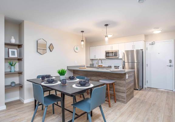 A kitchen with a dining table and chairs at G17 Apartments at Tamarack, Edmonton, AB