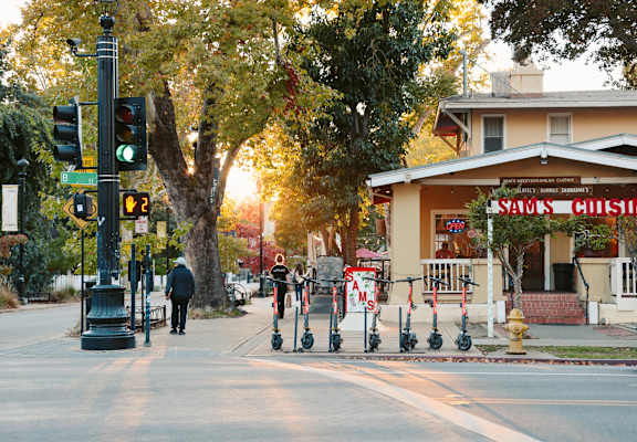 A street scene with a traffic light and a man walking.