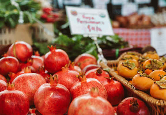 A basket of red pomegranates is on display.