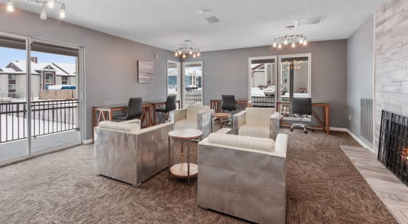 a living room with couches and chairs and a balcony at Eastwood Crossings in Kansas City, Missouri