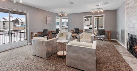 a living room with couches and chairs and a balcony at Eastwood Crossings in Kansas City, Missouri