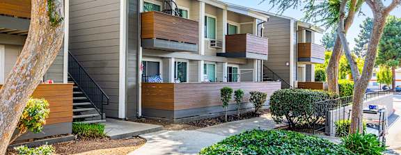 A modern apartment complex with a well-maintained courtyard.