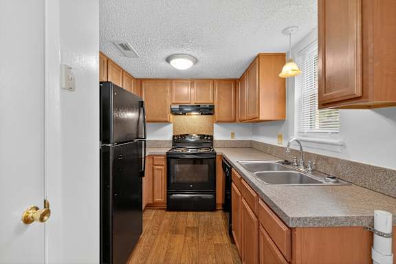 A spacious room with a carpeted floor and a ceiling fan. at Woodlocke Apartments, South Carolina, 27461
