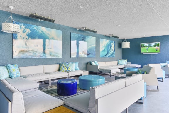 a living room with blue walls and white furniture  at Esprit Apartments, Marina del Rey, CA, 90292