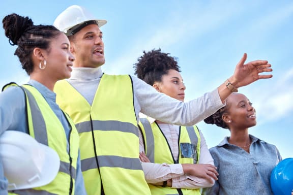 a group of construction workers in yellow vest and yellow safety vests