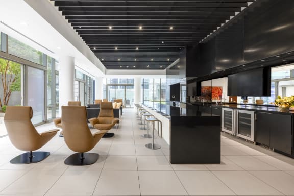 the lobby of a restaurant with chairs and a counter