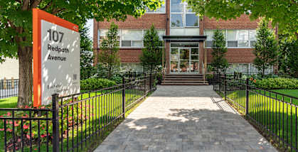The image shows a building entrance with a sign that reads at 107 Redpath, California, M4S 2J9