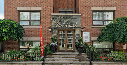 The front of a building with a sign at 391 Sherbourne Apartments, Toronto, ON, M4X 1K4