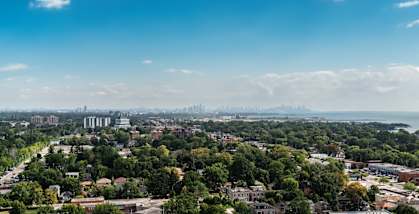 A cityscape with a mix of greenery and buildings under a clear sky. at 70 Park, Mississauga, CA