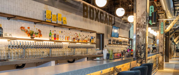 the bar at honeybee bar and grill with bottles of beer on the counter