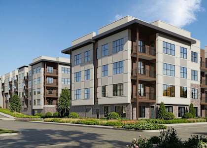 A large, modern apartment complex with multiple buildings and balconies.