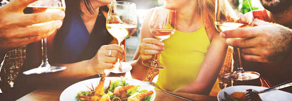 a group of people sitting at a table drinking wine at Mirabelle Luxury Apartments, Kansas City Missouri