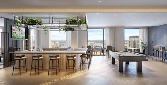 A modern bar with a pool table and a view of the city.