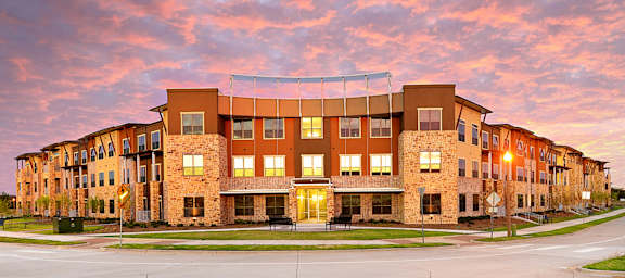 a building at sunset with the sky in the background