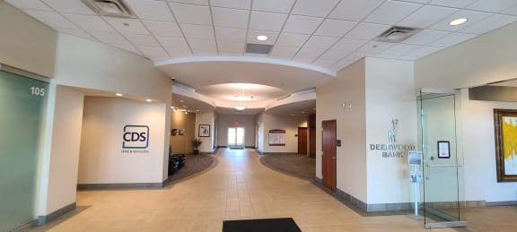 a view of a corridor in a building with a lobby and a door