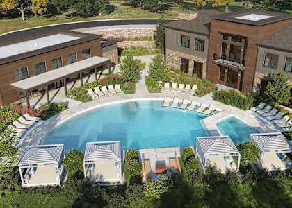 A large building with a pool in front of it. at The Maverick Luxury Apartments, Colorado