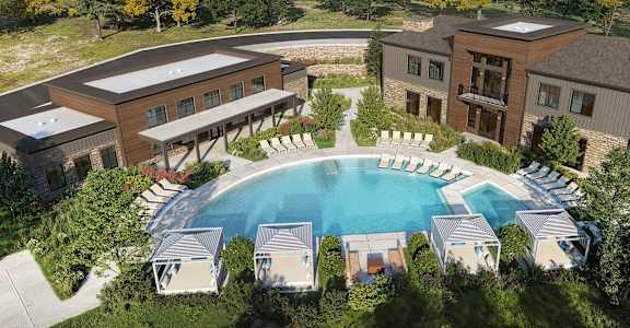 A large building with a pool in front of it.