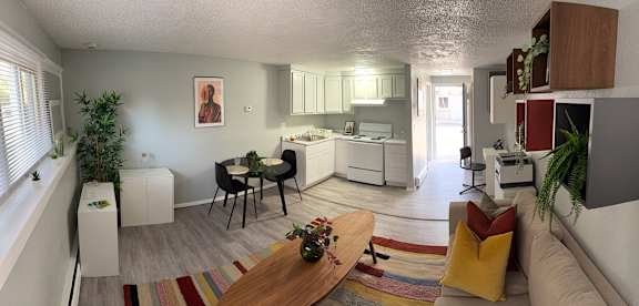 A kitchen with a bar stool and a couch.