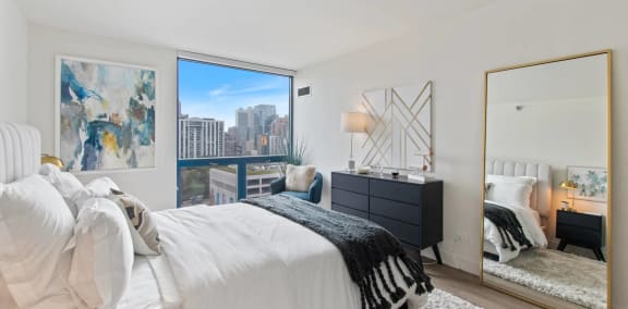 a bedroom with a bed and a large window