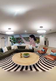 A modern living room with a large circular coffee table in the center.at 2231 S Western, Los Angeles California