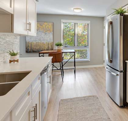 A modern kitchen with a stainless steel refrigerator and oven.