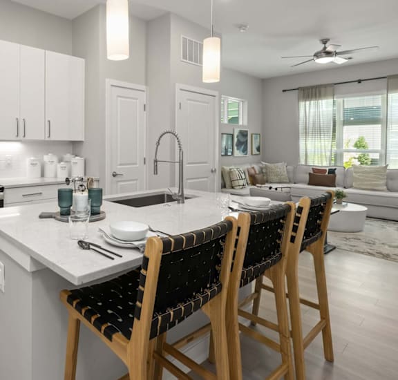 A modern kitchen with white cabinets and a central island.