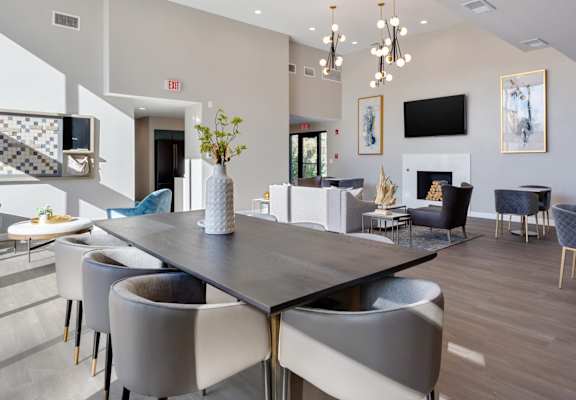 A modern dining room with a large table and chairs.
