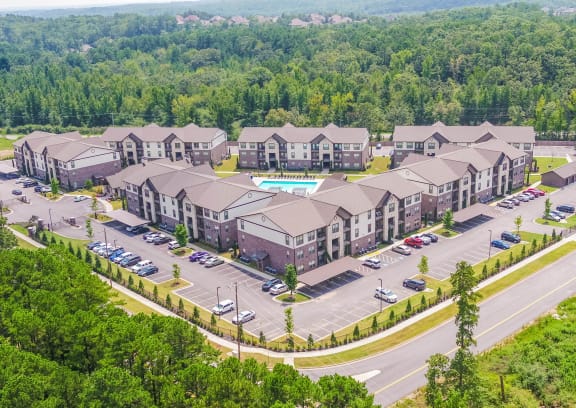 an aerial view of a building surrounded by trees at The McKenzie Park Apartments, Little Rock, 72223