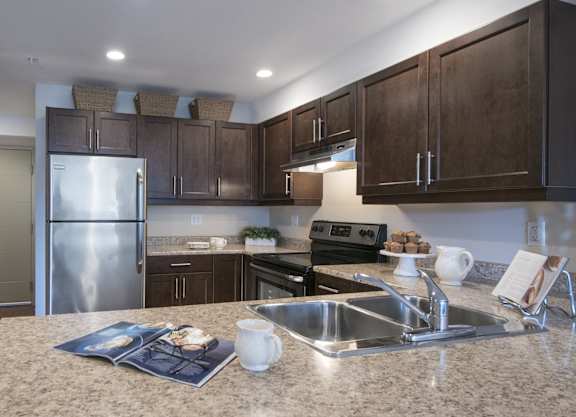 a kitchen with stainless steel appliances and granite counter tops